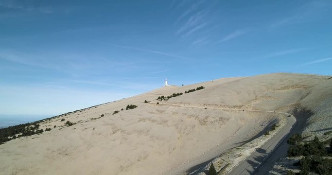 Car drives down road on Mont Ventoux, France in epic landscape