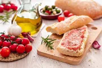 Fototapeta na wymiar rustic bread, tomato and olive oil ready to make toasts