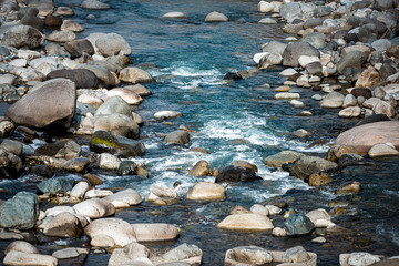 Fototapeta na wymiar Takayama, Japan in Gifu Prefecture view from road leading to Okuhida Villages and Shinhotaka Ropeway countryside rural area with pristine river blue water in mountains flowing on rocks stones