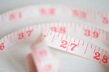 pink measuring tape dieting watching weight 