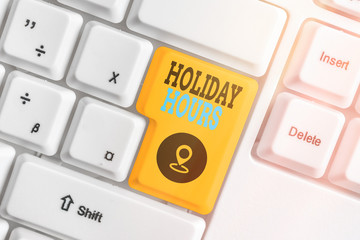 Writing note showing Holiday Hours. Business concept for employee receives twice their normal pay...