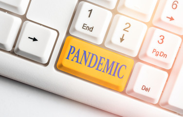 Writing note showing Pandemic. Business concept for occurring over a wide area affecting high...