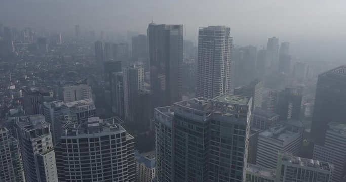Ungraded, Ascending aerial flight through business district revealing metropolitan city's skyline. Drone, 4K.