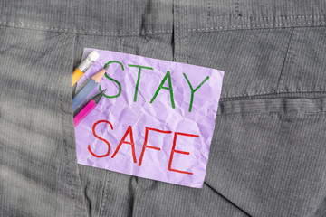Conceptual hand writing showing Stay Safe. Concept meaning secure from threat of danger, harm or...