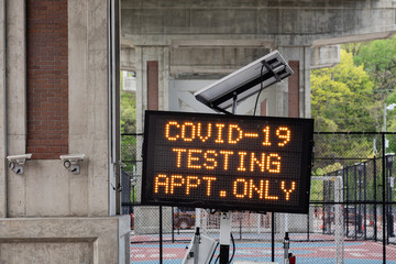 Hoboken, NJ/USA - May 4th 2020 : Sign for Coronavirus drive through testing site under the viaduct