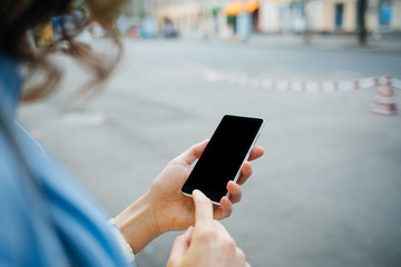 Unrecognizable young woman using mobile phone