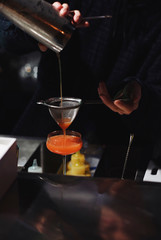 bartender is preparing a cocktail