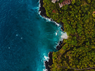 Blue sea in tropical island with rocky coastline. Aerial view.