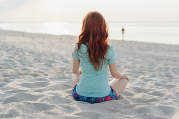 Young woman relaxing on the sand on a beach