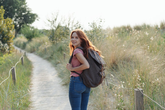 Pretty healthy woman backpacking in coastal dunes