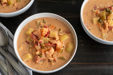 Smoked Salmon Chowder: Three bowls of chowder made with seafood and vegetables 