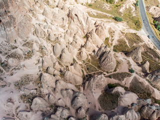 Aerial view of Goreme National Park, Goreme Tarihi Milli Parki, Turkey. The typical rock formations of Cappadocia with fairy chimneys and desert landscape. Travel destinations, holidays and adventure