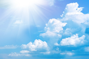 Naklejka na ściany i meble Blue sky with white clouds and sun. Nature background