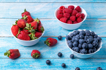 Berries, summer fruits on a wooden table. Healthy lifestyle concept. 