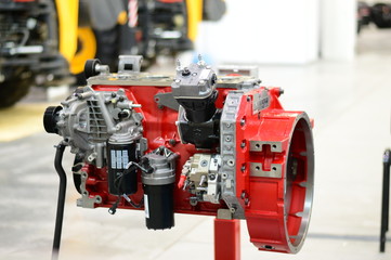 Red disassembled tractor engine stands