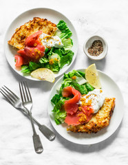 Potato tortilla frittata with natural greek yogurt, smoked salmon and green salad on a light background, top view. Delicious breakfast, appetizer, tapas