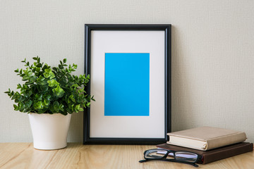 Mockup of a black photo frame with Passepartout. The light interior in the Scandinavian style