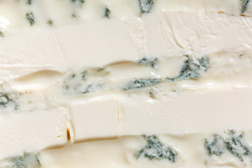A mixture of gorgonzola cheeses with mascarpone macro. Light background eating dairy product.