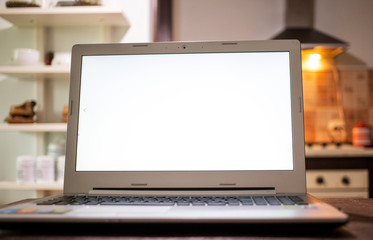 Fototapeta premium empty laptop screen in kitchen copy space