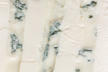 A mixture of gorgonzola cheeses with mascarpone macro. Light background eating dairy product.