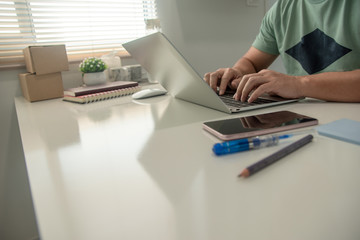 Men are using laptops on their dining tables at home. Working at home during the epidemic virus.