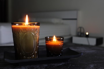 The lighting aroma scented candles on the black stone table in the dark bed room