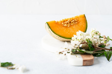 Fresh Cavaillon melon with white flowers on a white background.