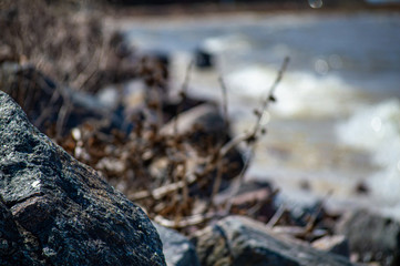 Gray stone on blur sea beach background