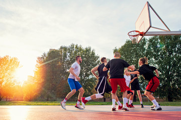 Group Of Young Friends Playing Basketball Match