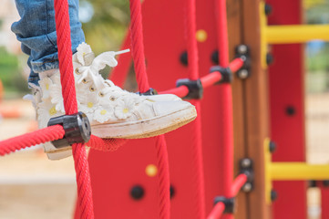 cute beautiful smiling little girl on a playground. Summer time fun