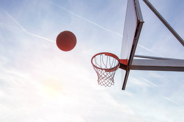 Young man jumping and making a fantastic slam dunk playing streetball, basketball. Urban authentic. © FS-Stock