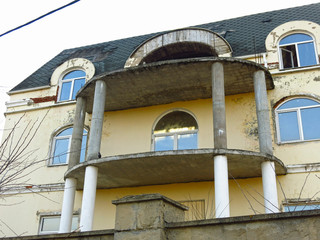 a huge beautiful abandoned mansion is being destroyed: rotting, moss on the roof, plaster collapses, gutters have fallen, the porch is broken, everything is overgrown with grass