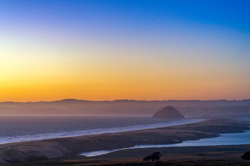 Sunset over Bay, Rock, Hills, Mountains from View 