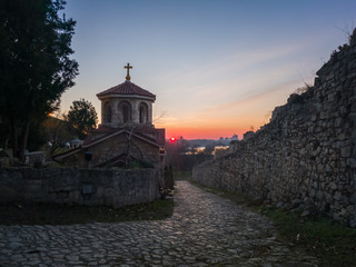 Saint Petka church (Crkva Svete Petke) in Kalemegdan fortress or Belgrade fortress (Beogradska tvrđava) on the hill above confluence rivers Sava and Danube at sunset.