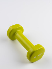 Small diagonal green dumbbell on white background