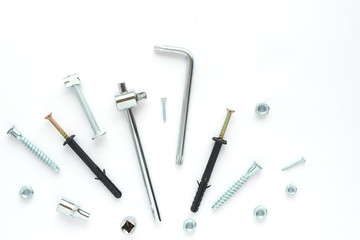 fasteners and tools on a white background. flat layout, top view. Space for text..