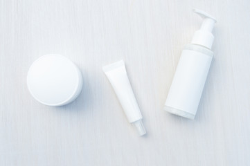 Isolated SPA cosmetic products, a white tube, a jar with a dispenser and a cream jar on a white background. Branding layout, top view.