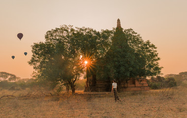 Woman watches the sunrise in Bagan, Myanmar