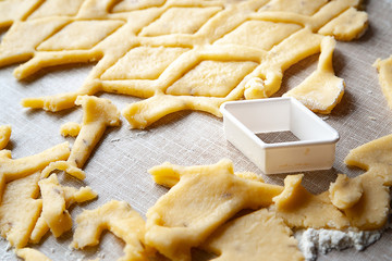 Cookie cutting. Forming baking dough with a cookie cutter. Selective soft focus.