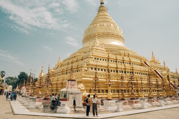 Couple visits the Shwezigon Pagoda, Bagan, Myanmar