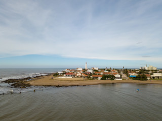 Aerial view of the lighthouse of La Paloma, the town next to it. Located in Rocha, Uruguay.