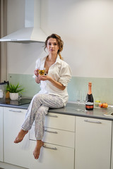 Girl sitting in the kitchen with a cup of tea