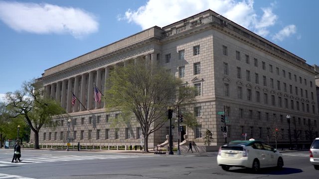 Panning shot of the US Department of Commerce federal building on a beautiful day in Washington, DC.