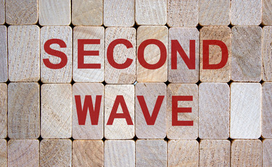 Wooden blocks form the words 'second wave'. Beautiful wooden background.