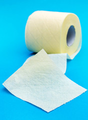 Roll of toilet paper on blue background.