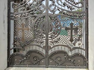 Metal openwork gates to the right-wing monastery. The church building.