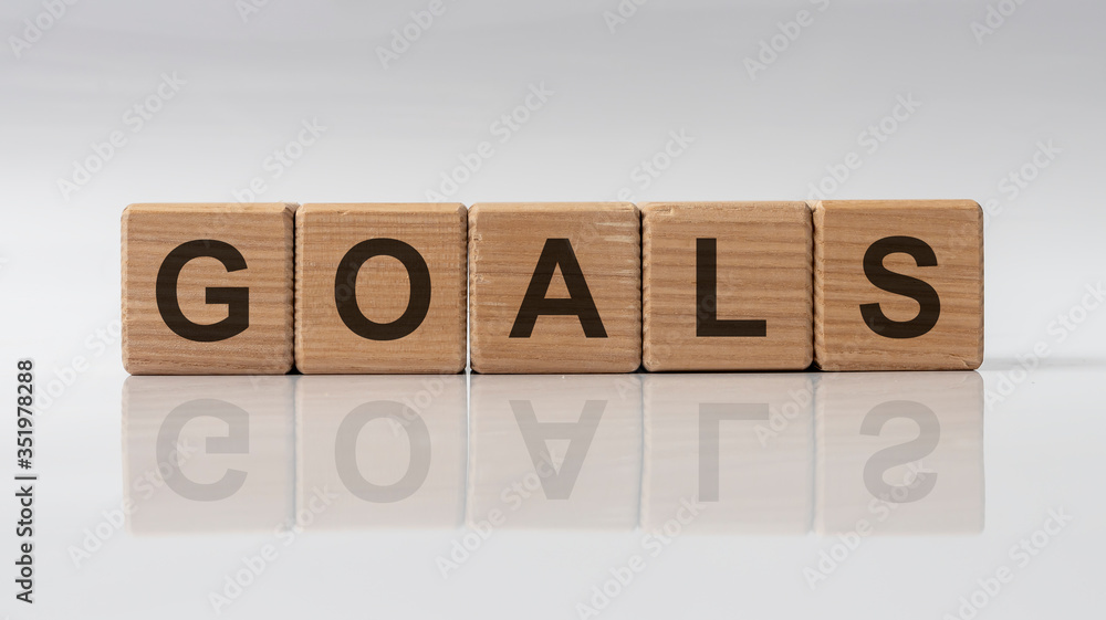 Poster goals word text on cube blocks with reflection on white glossy background