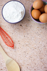 Kitchen utensils for cooking, eggs and flour in bowl