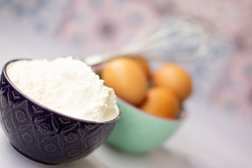 Kitchen utensils for cooking, eggs and flour in bowl