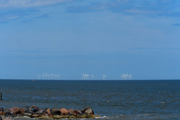 Fototapeta na wymiar Windmills at sea